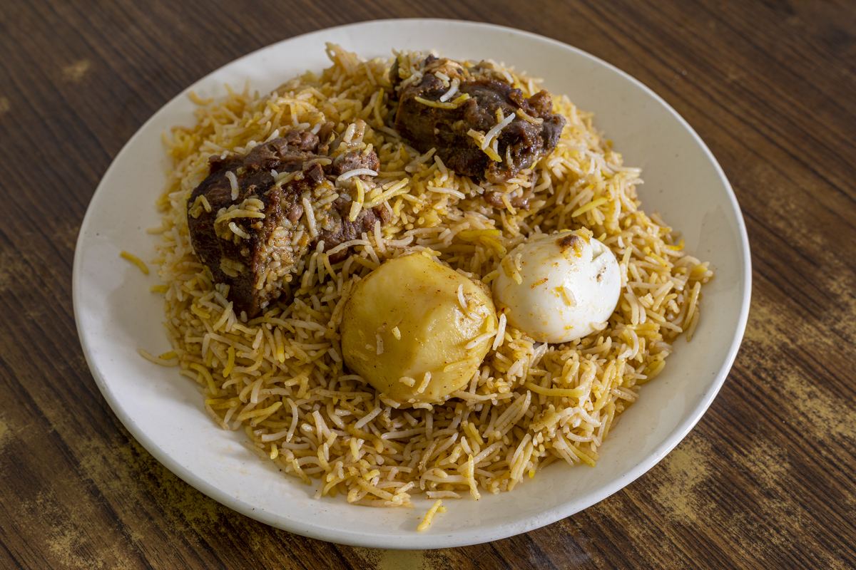 Fragrant biryani rice dish plated with meat and boiled egg