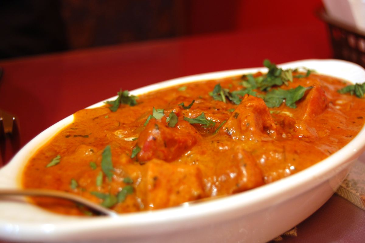 Creamy butter chicken curry garnished with cilantro