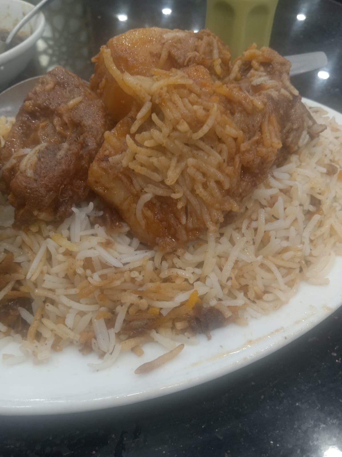 Kacchi biryani plated with grilled kabab