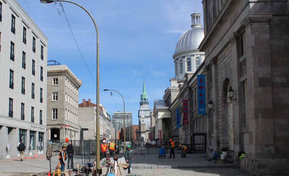 Historic storefronts along a cobblestone street in Old Montreal near the restaurant