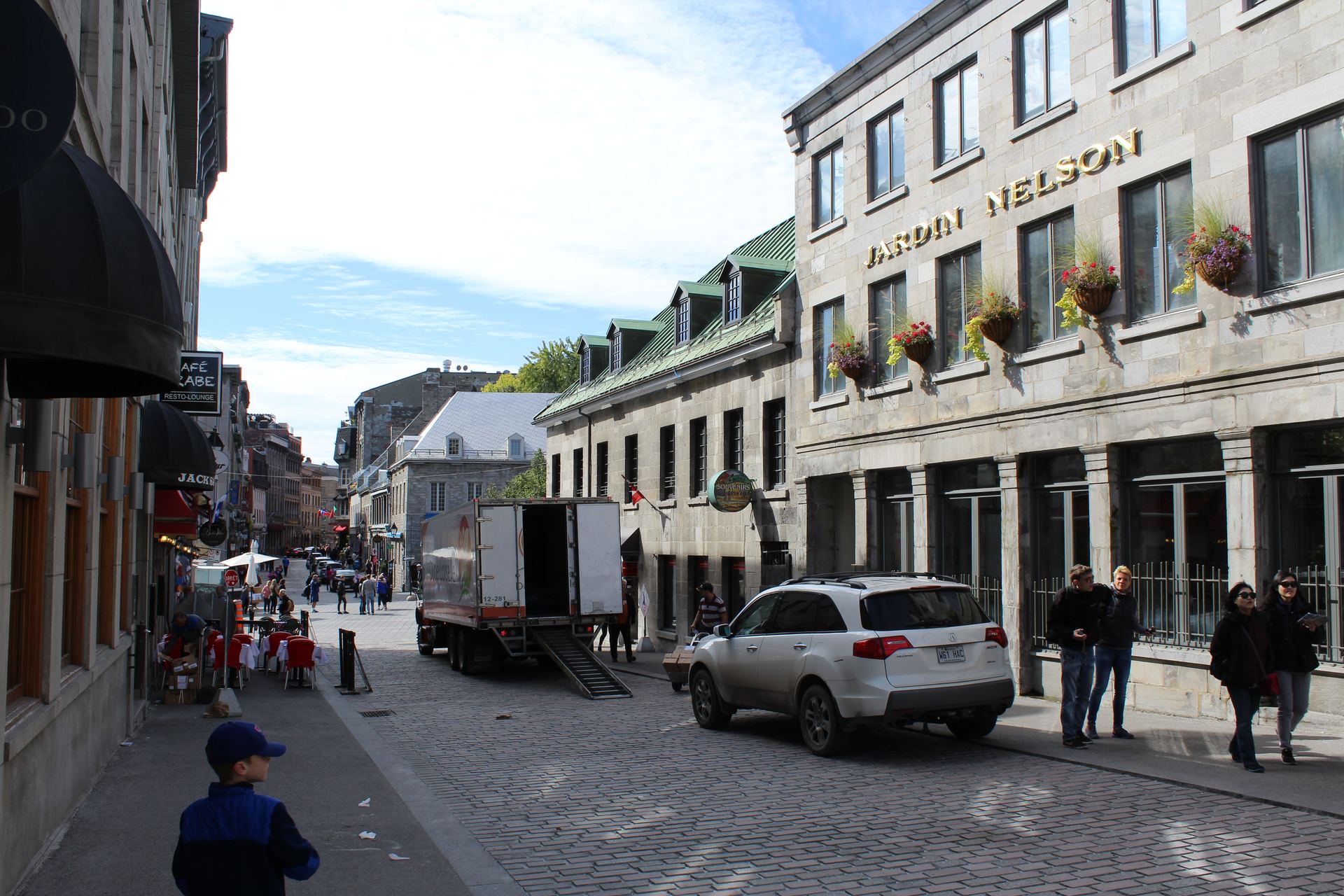 Historic cobblestone street of Old Montreal with stone buildings, near Restaurant Gandhi